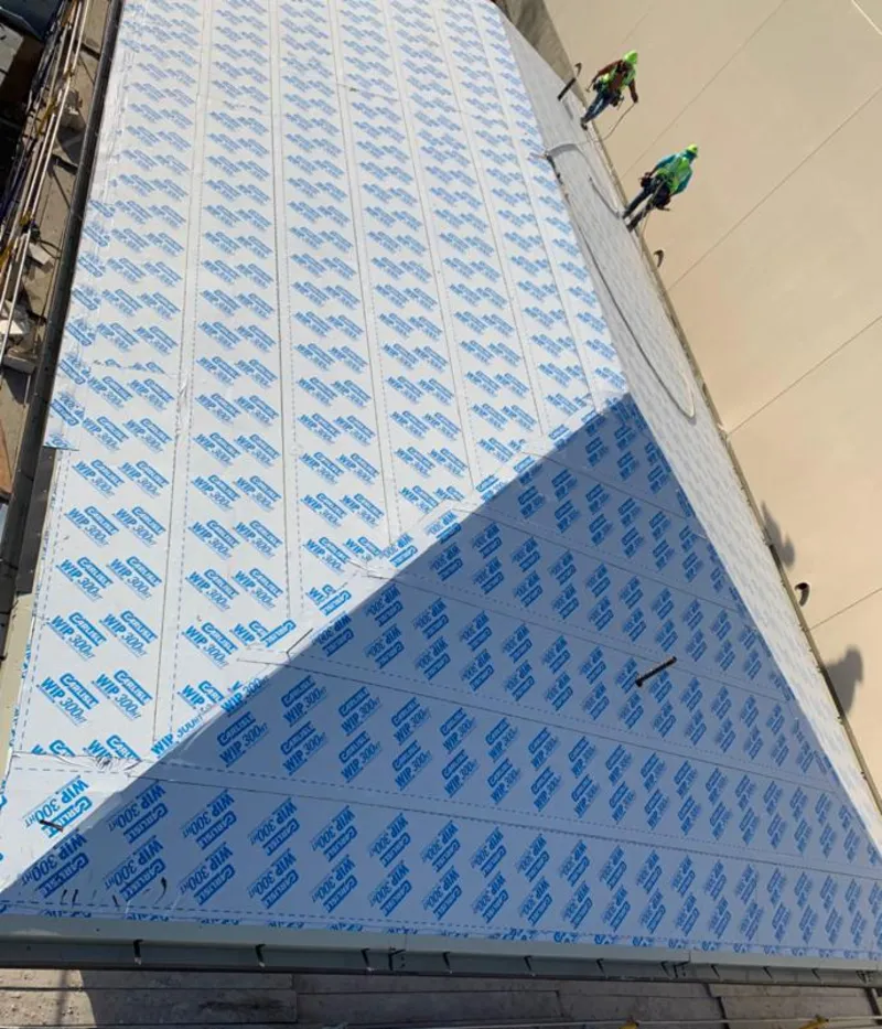 Professional roofers installing underlayment on a metal roof in Scranton